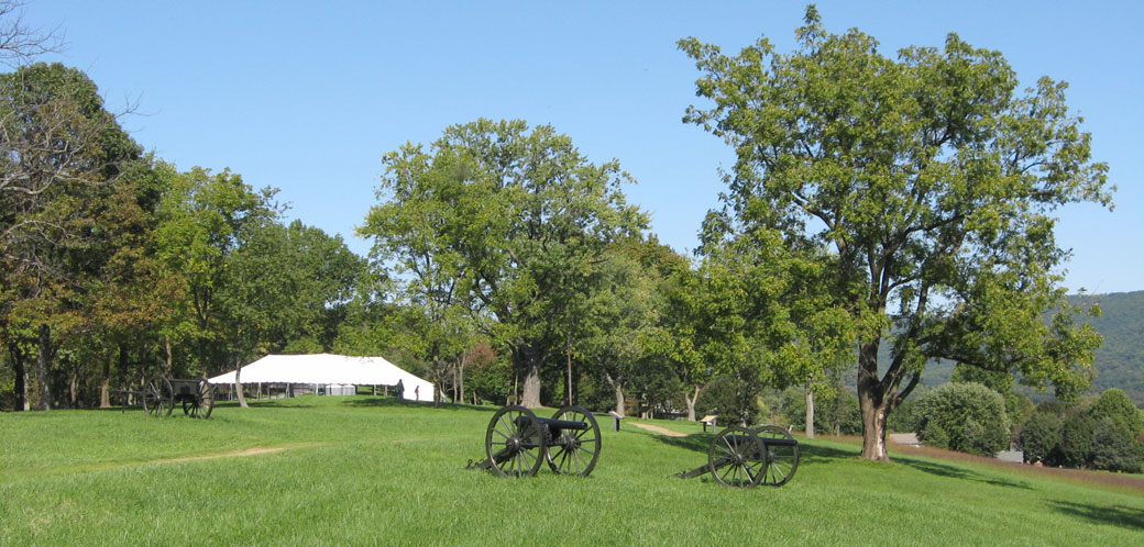 Looking north along the east side of the Union Battle Line Loop Trail on Bolivar Heights at Harpers Ferry National Military Park. The Confederate Victory and A Union Predicament wayside markers can be seen in the middle of the photo beyond the cannon.