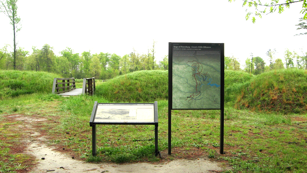 Two markers outside the entrance to Fort Fisher at Stop Three on the Western Front Auto Tour.