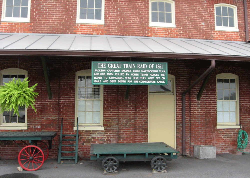 A Strasburg Museum building and sign for "Stonewall" Jackson's Great Train Raid of 1861 are at the Strasburg Museum in Strasburg, Virginia.