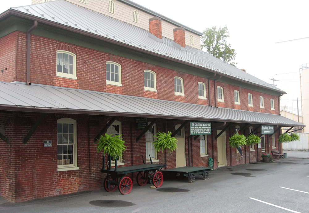 A Strasburg Museum building and sign for "Stonewall" Jackson's Great Train Raid of 1861 are at the Strasburg Museum in Strasburg, Virginia.