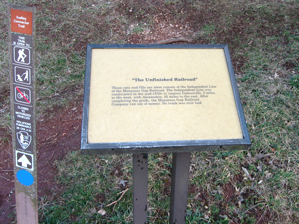 The Unfinished Railroad trailside marker is next to the parking area at Stop 5 on the Manassas Battlefield Driving Tour.