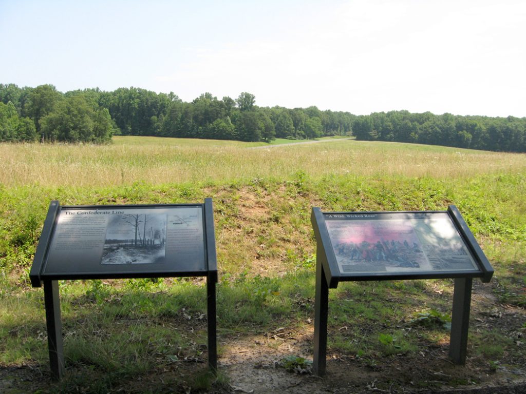 The 'A Wild, Wicked Roar' and 'Confederate Line' wayside markers on the Wilderness battlefield